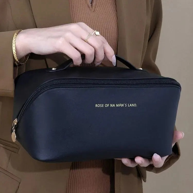 Black travel toiletry bag with top handle
