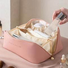 Pink toiletry bag with cosmetics in its interior sections
