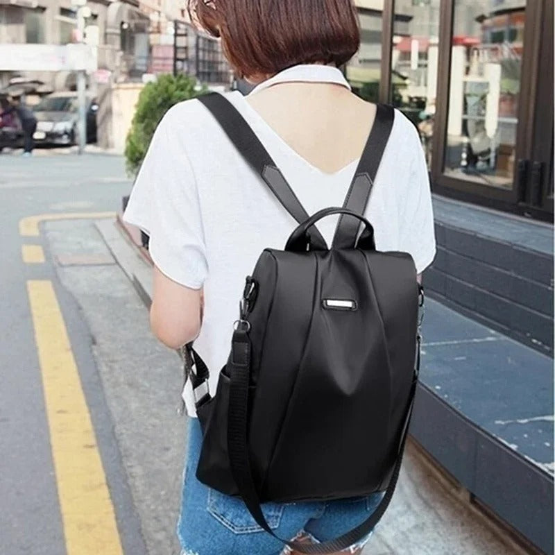 Black convertible backpack worn outdoors