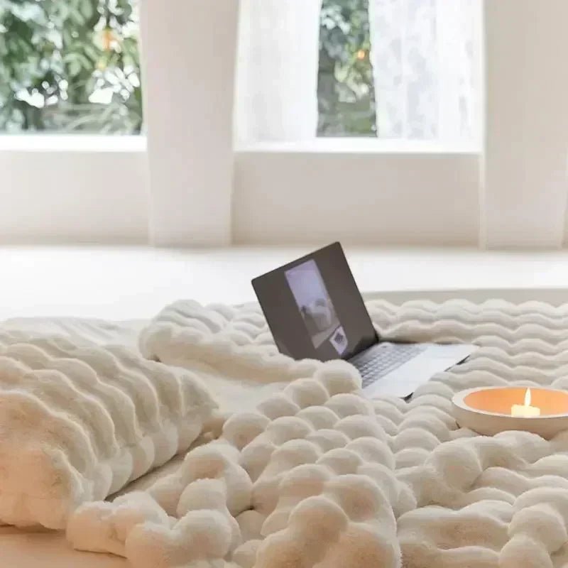 Faux-fur textured throw styled on a sofa