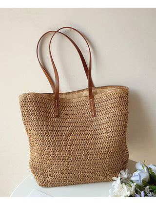 Brown woven tote bag displayed upright