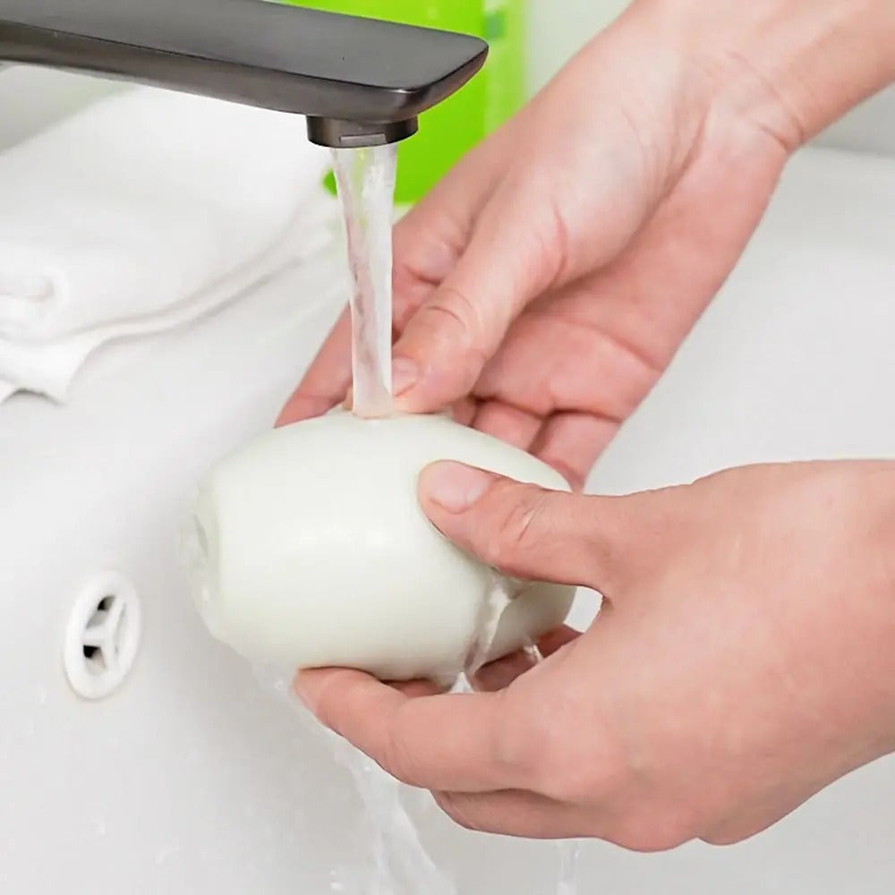 Reusable lint remover rinsed under a faucet