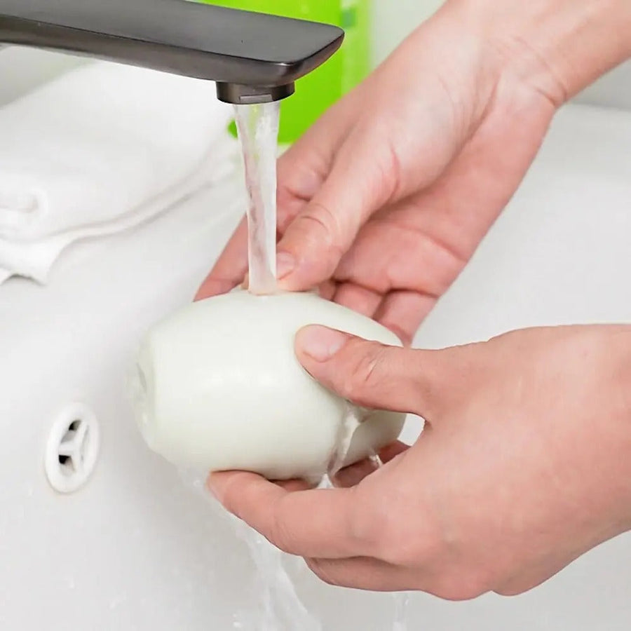 Reusable lint remover rinsed under a faucet