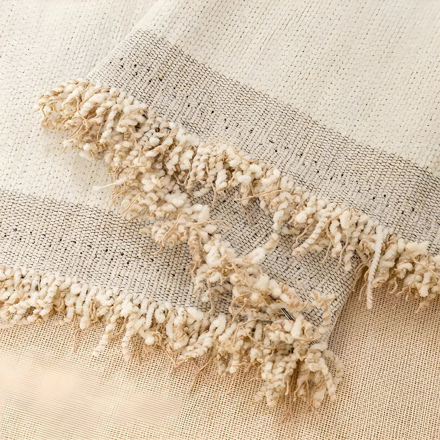 Close view of the woven edge and fringe on the sofa throw