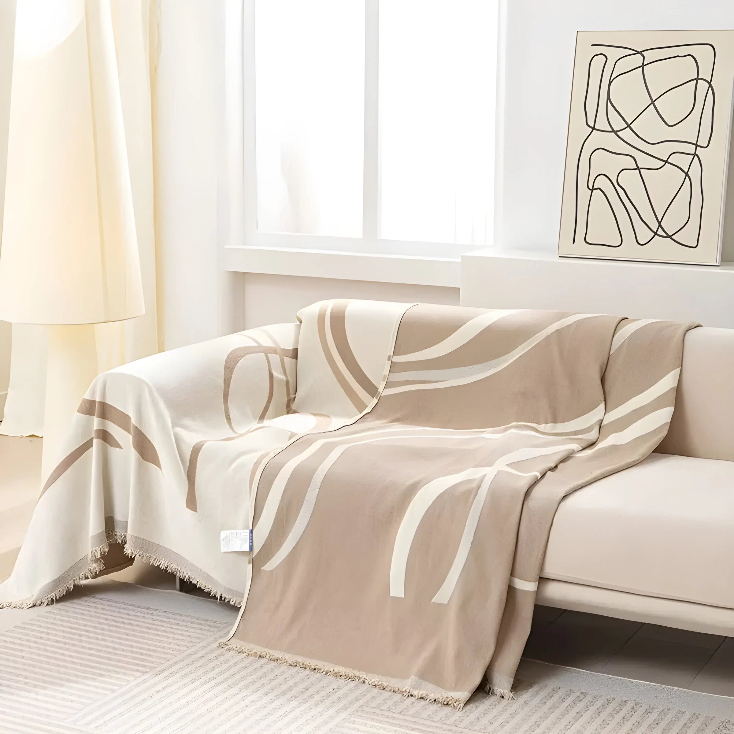 Khaki sofa throw draped loosely over a couch