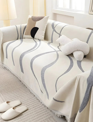 Gray reversible chenille-cotton throw draped over a sofa