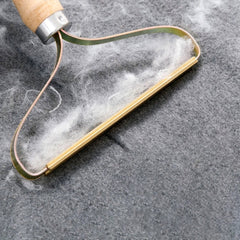 Curved lint-removal edge shown on gray fabric