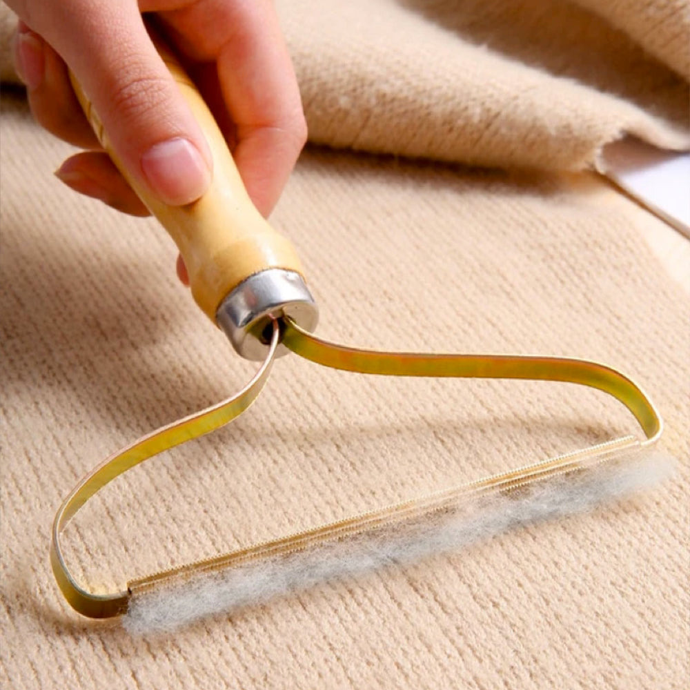 Manual lint remover used on beige fabric