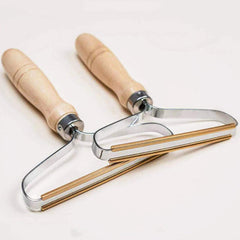 Two portable lint removers with rounded handles
