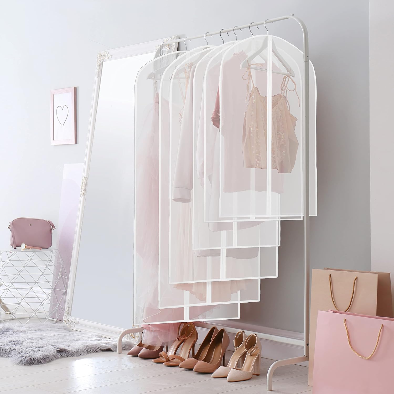 Translucent garment covers arranged on a bedroom clothing rack
