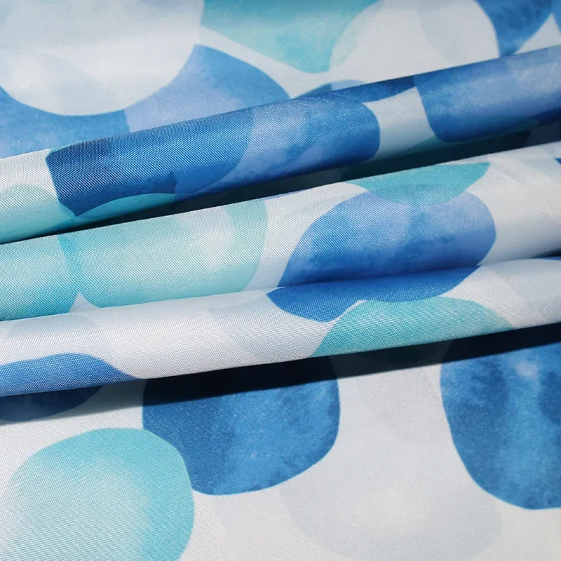 Folded blue patterned polyester curtain fabric