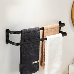 Three-bar towel rack holding assorted towels