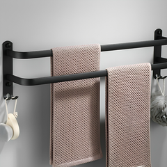 Three-bar towel rack holding two textured towels