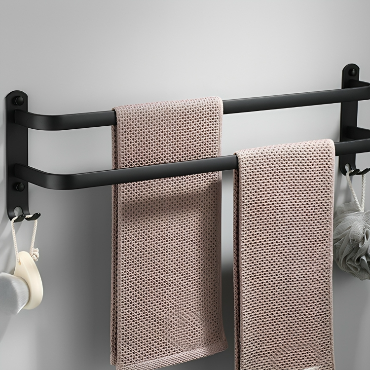 Three-bar towel rack holding two textured towels