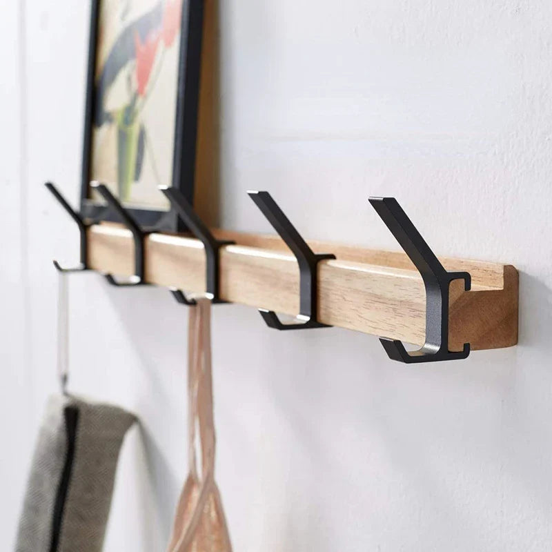 Close view of movable black hooks on a wood rail