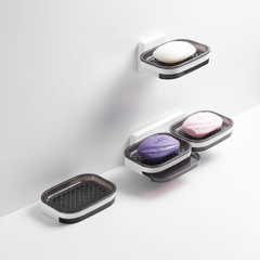 Single and double wall-mounted soap dishes holding bar soap
