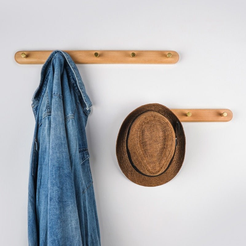 Beech wall coat racks holding a scarf and hat